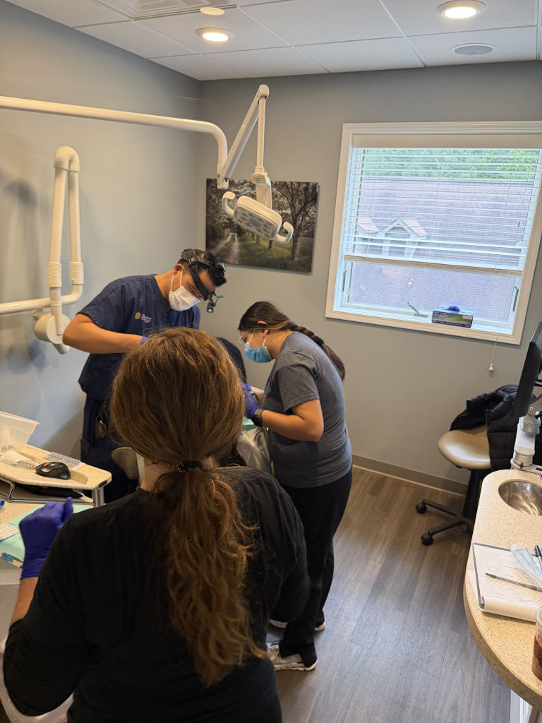 The Zoe Dental Team and Southern Dental Implants and Oral Surgery Team providing donated dental services to a patient on Servants of Smiles 2026 in Asheville, NC.